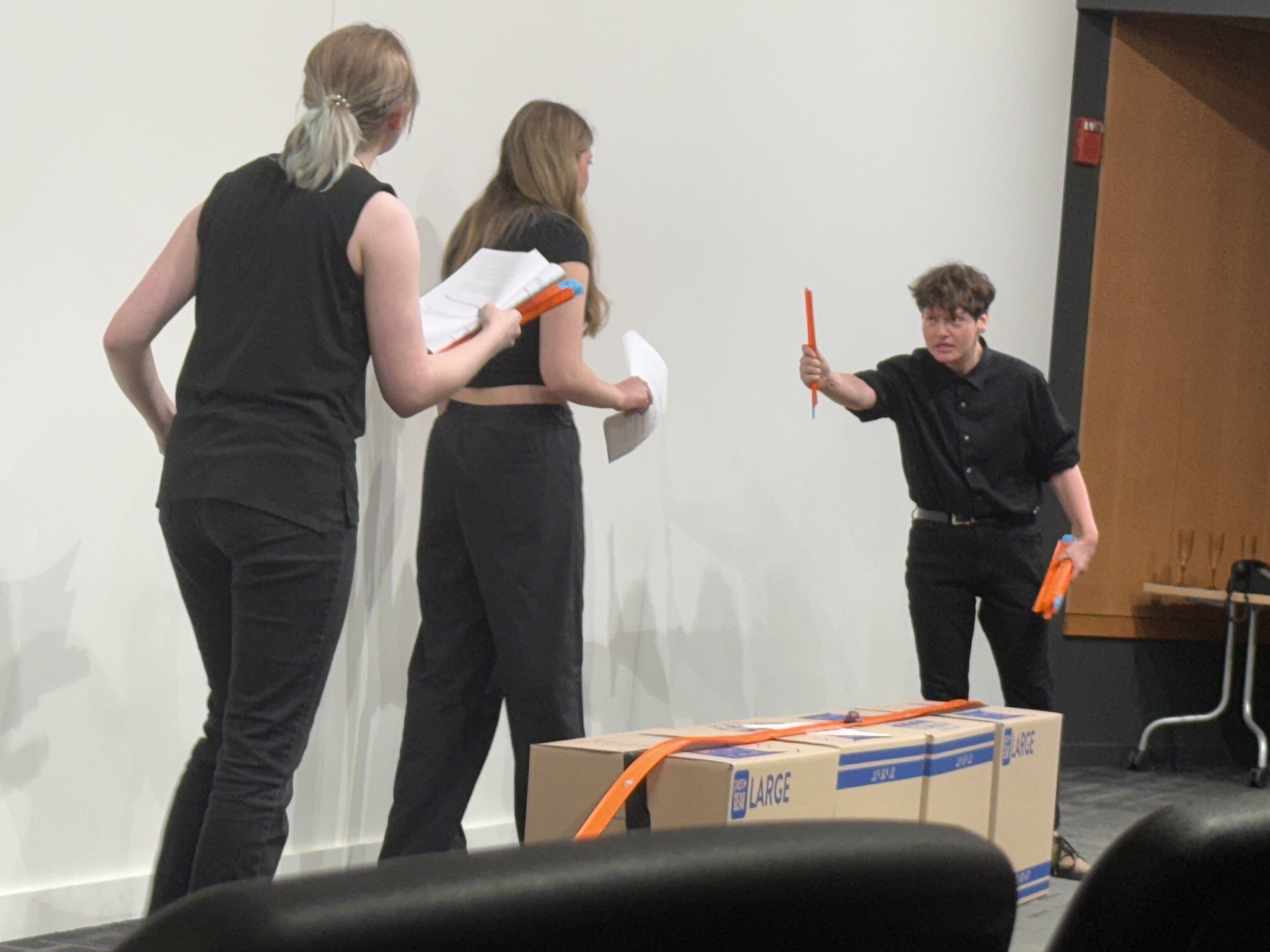 Tobias Sanders as Id holding a piece of hot wheels track aggressively as Ella Galens and Veronica Thomas look on