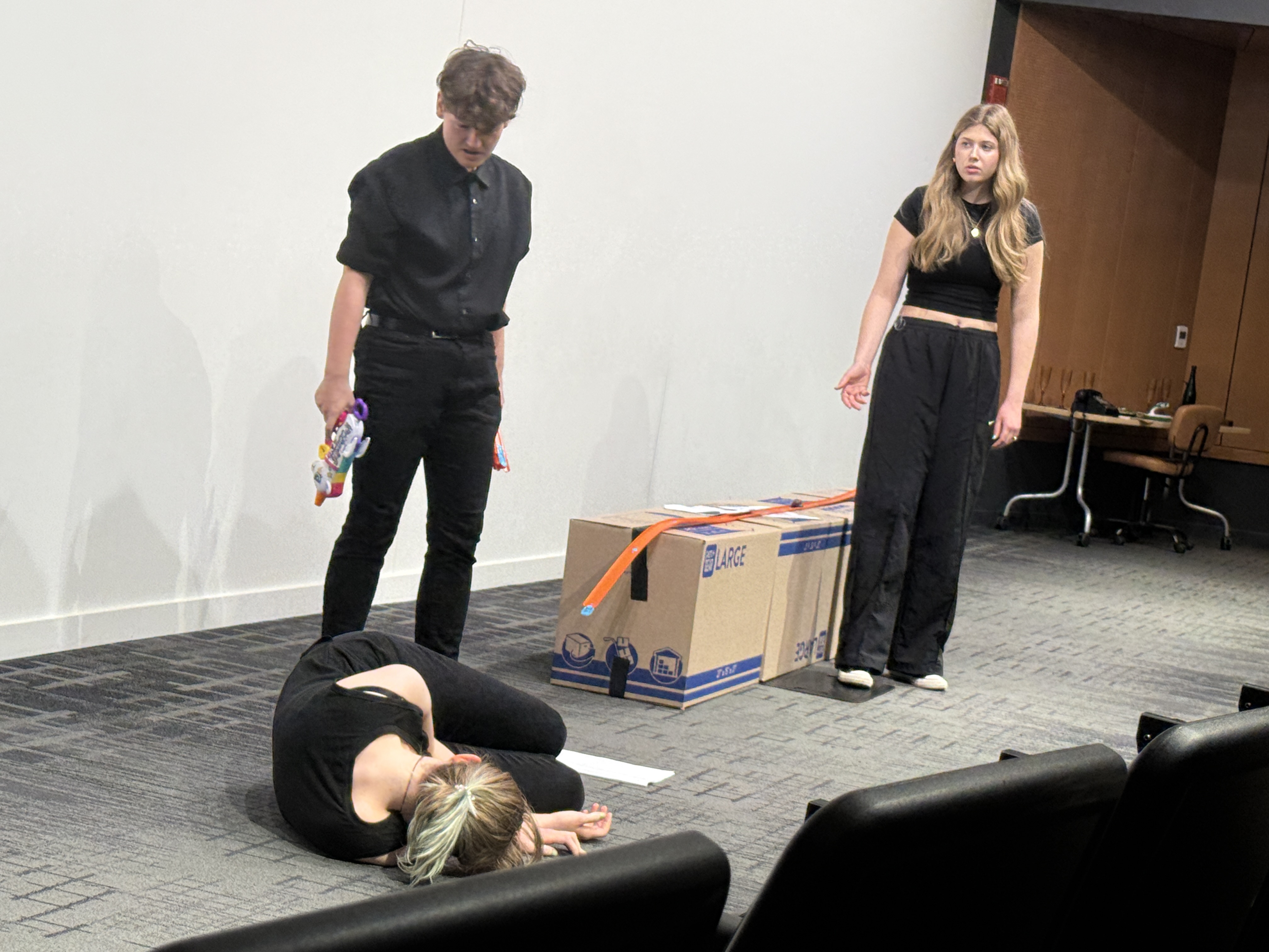 Tobias Sanders as Id looking over Veronica Thomas as Superego as Ella Galens as Ego looks on in in "Apathy" in the Facility for Rare Isotope Beam (FRIB) Produced by Second Stage Playwriting