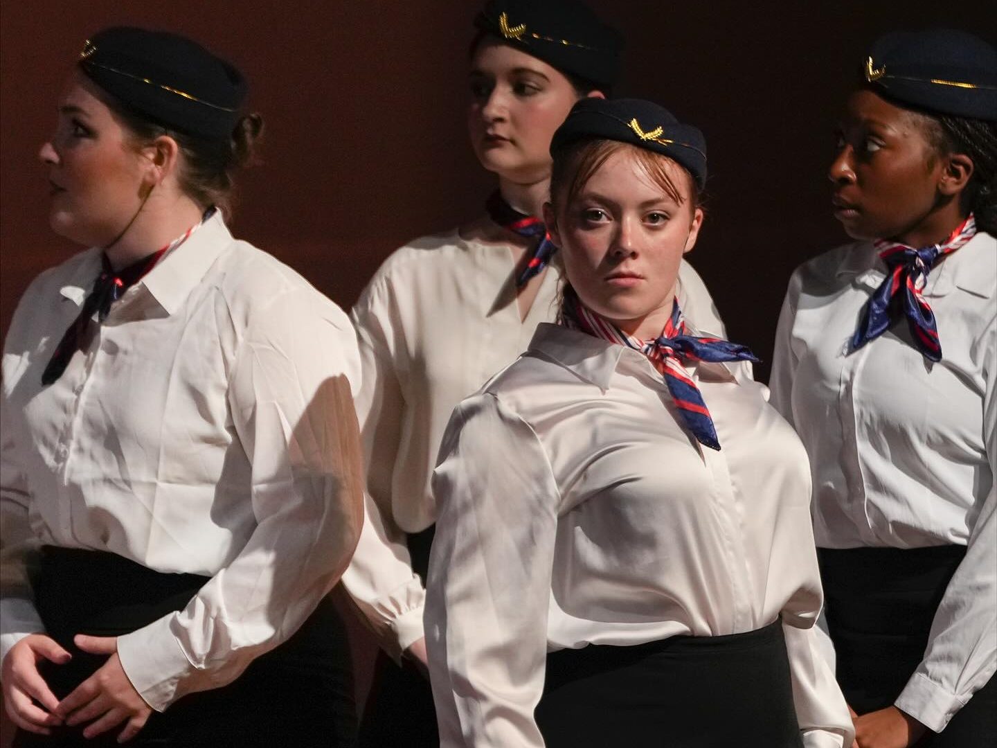 Gracie Duffy as May, Brooke Cousins as June, and Aubriana Scott as Julie standing behind Anastasia Breen in MSU's New Musical Laboratory's production of "Taking Off" 