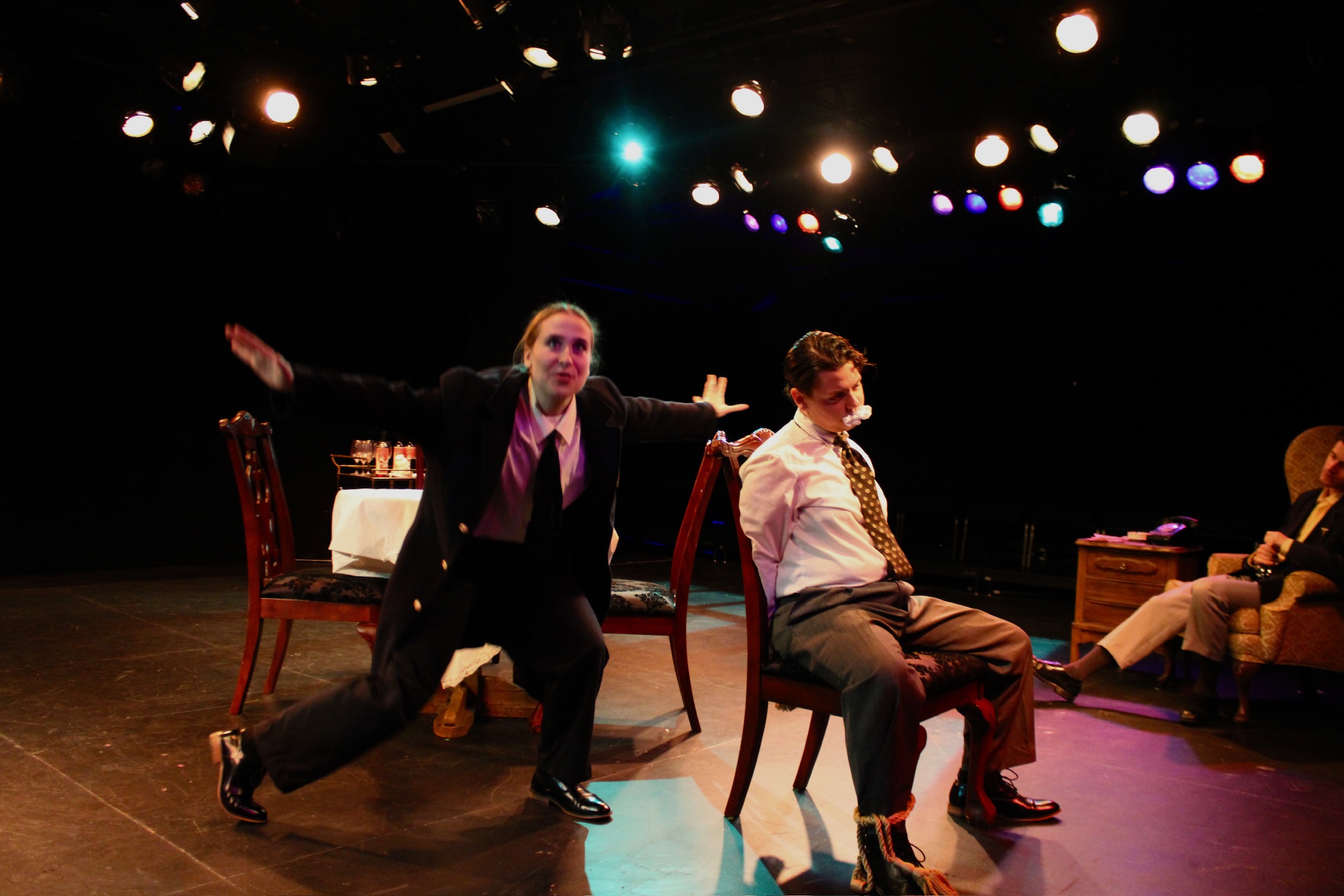 Olivia Welch as Officer O'Hara telling a story to a tied up Tobias Sanders as Mortimer Brewster in Second Stage Productions "Arsenic and Old Lace"