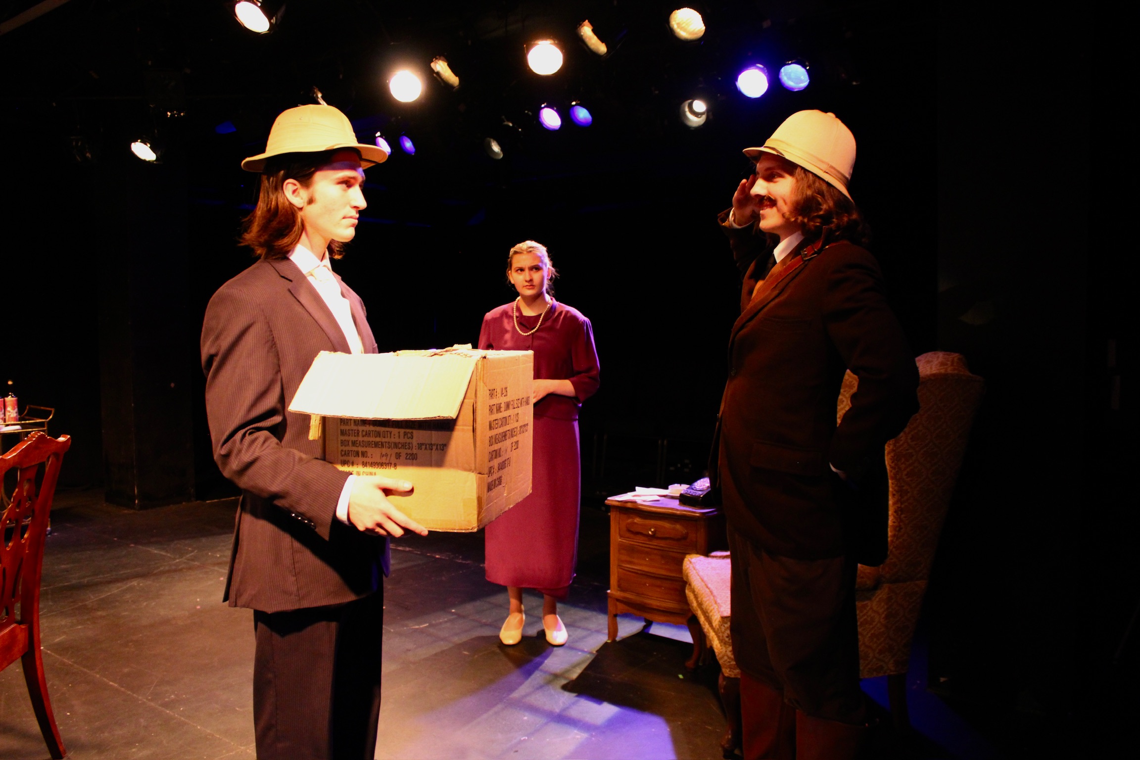 Sorine Andronic as Mr. Witherspoon holding a box with Noah Trapp as Teddy Brewster and Iris Widlansky as Abby Brewster in Second Stage Productions "Arsenic and Old Lace"