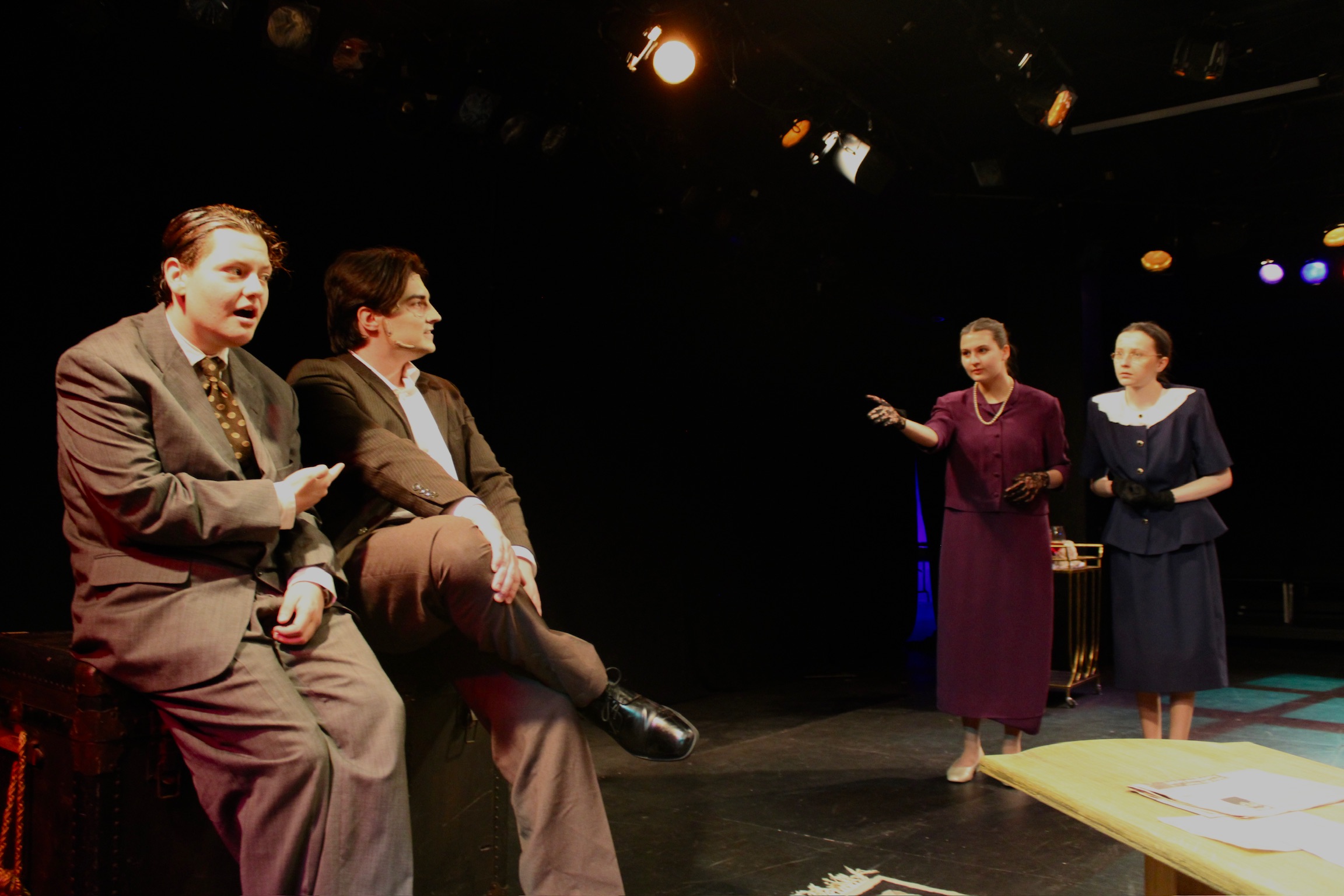 Tobias Sanders as Mortimer Brewster and Tyler Radze as Jonathan Brewster sitting on a window seat with Iris Widlansky as Abby Brewster and Caitlyn Myers as Martha Brewster in Second Stage Productions "Arsenic and Old Lace"