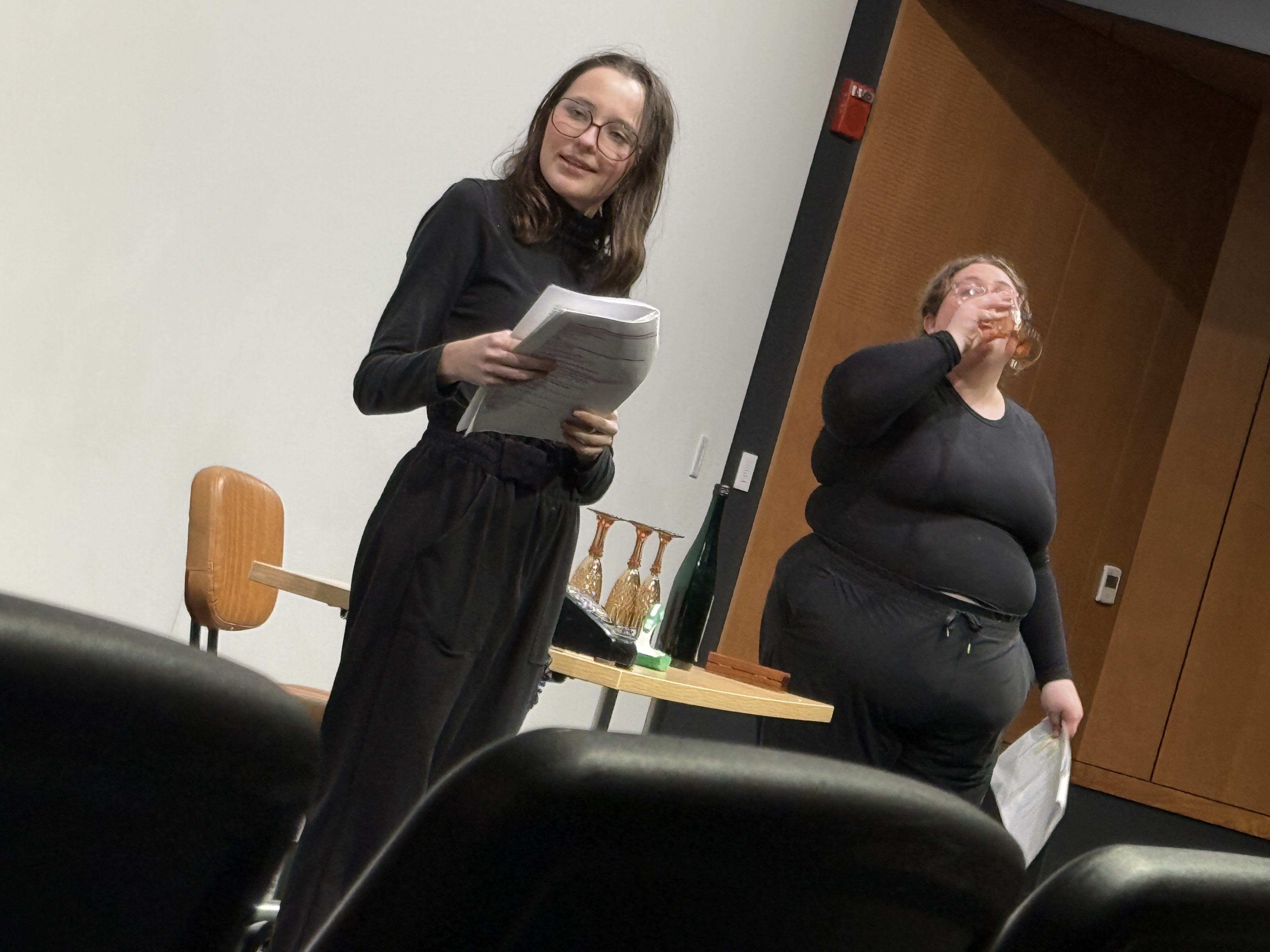 Caitlyn Myers playing Jo being sneaky and Reese Verlinde playing Margaret drinking in the background "Nuclear" at the Facility for Rare Isotope Beams (FRIB) produced by Second Stage Playwriting