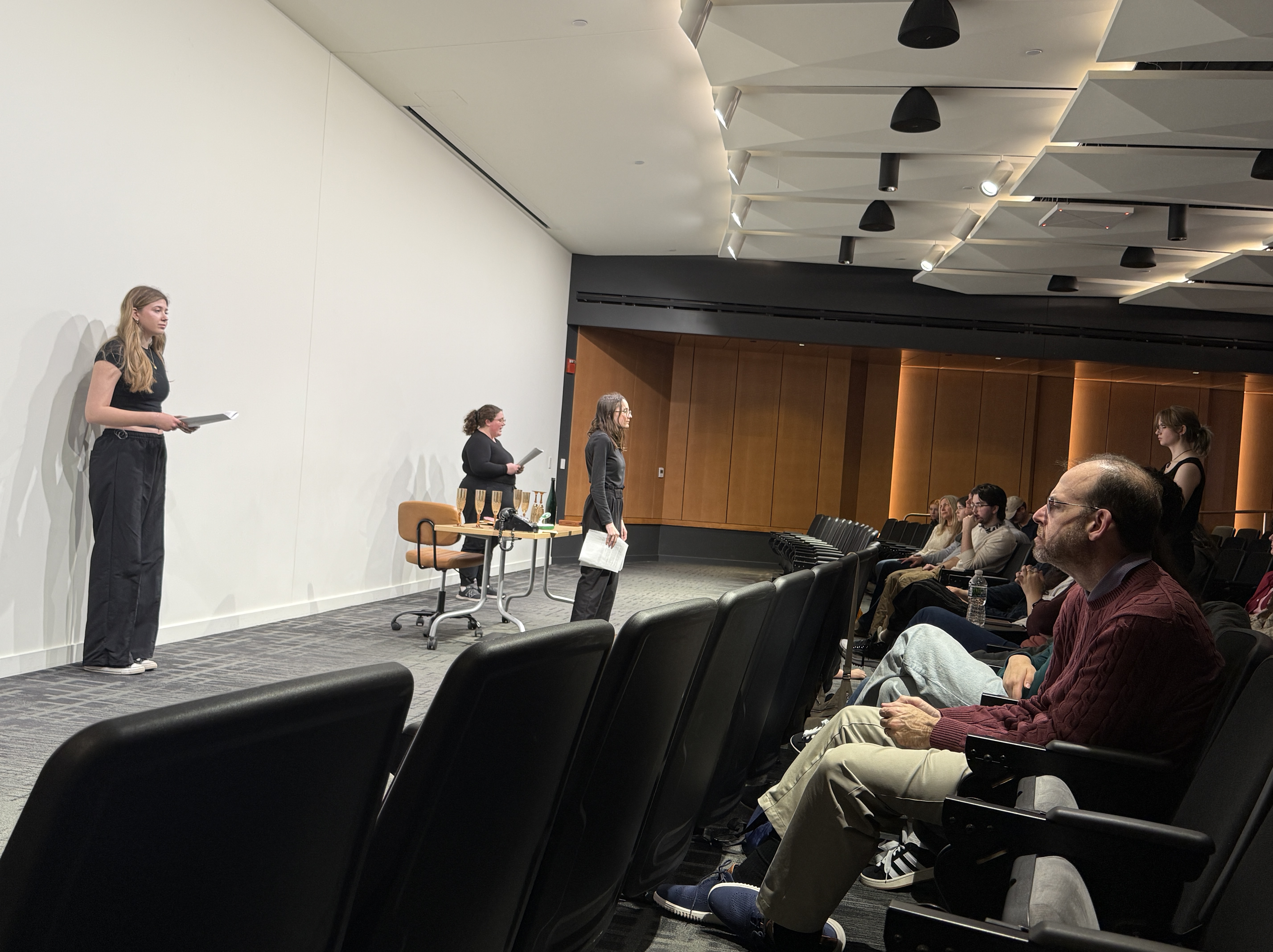Caitlyn Myers as Jo standing trial with Ella Galens as 1950's reporter and Reese Verlinde as a modern reporter forming a triangle in "Nuclear" with Veronica Thomas at the Facility for Rare Isotope Beams (FRIB) produced by Second Stage Playwriting