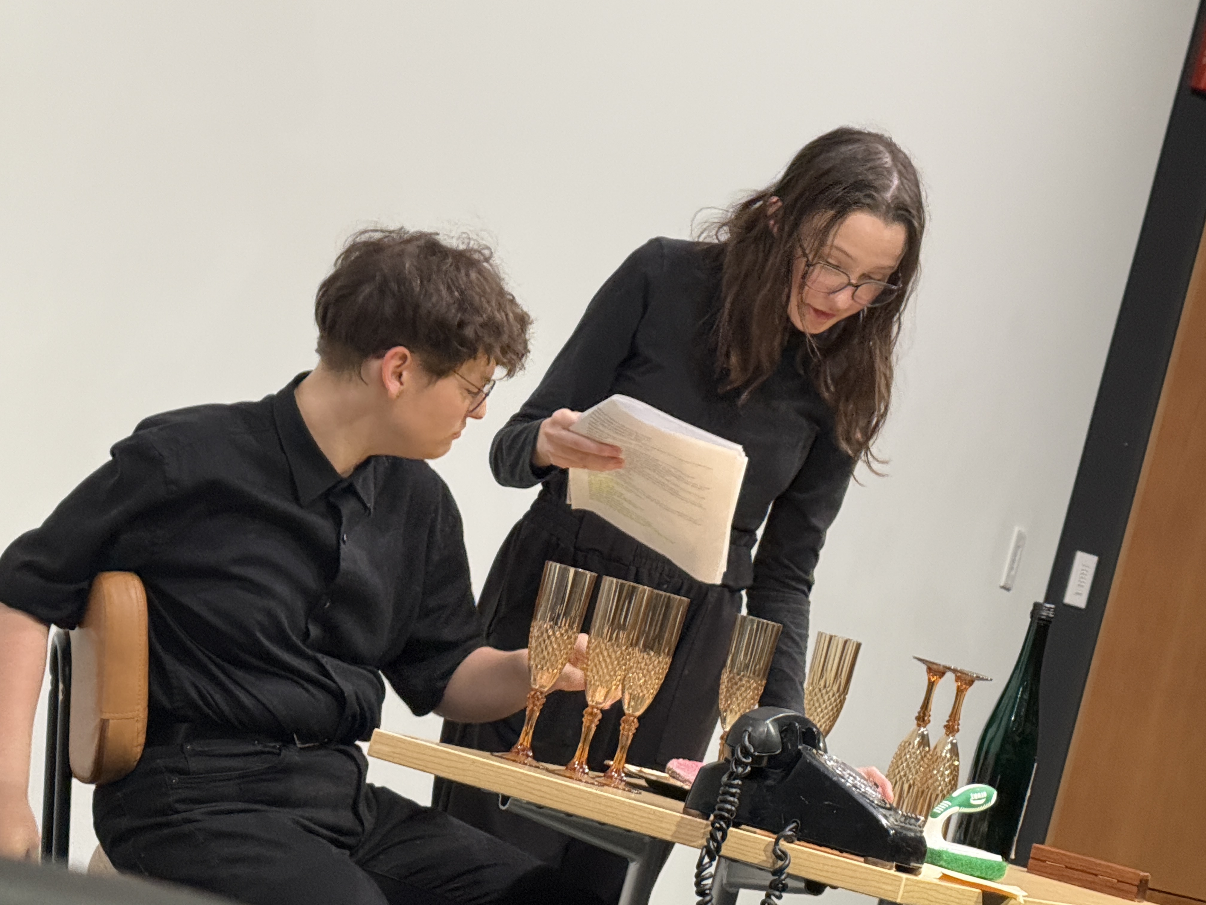 Caitlyn Myers as Jo preparing meal for Tobias Sanders as Micheal in "Nuclear" at the Facility for Rare Isotope Beams (FRIB) produced by Second Stage Playwriting