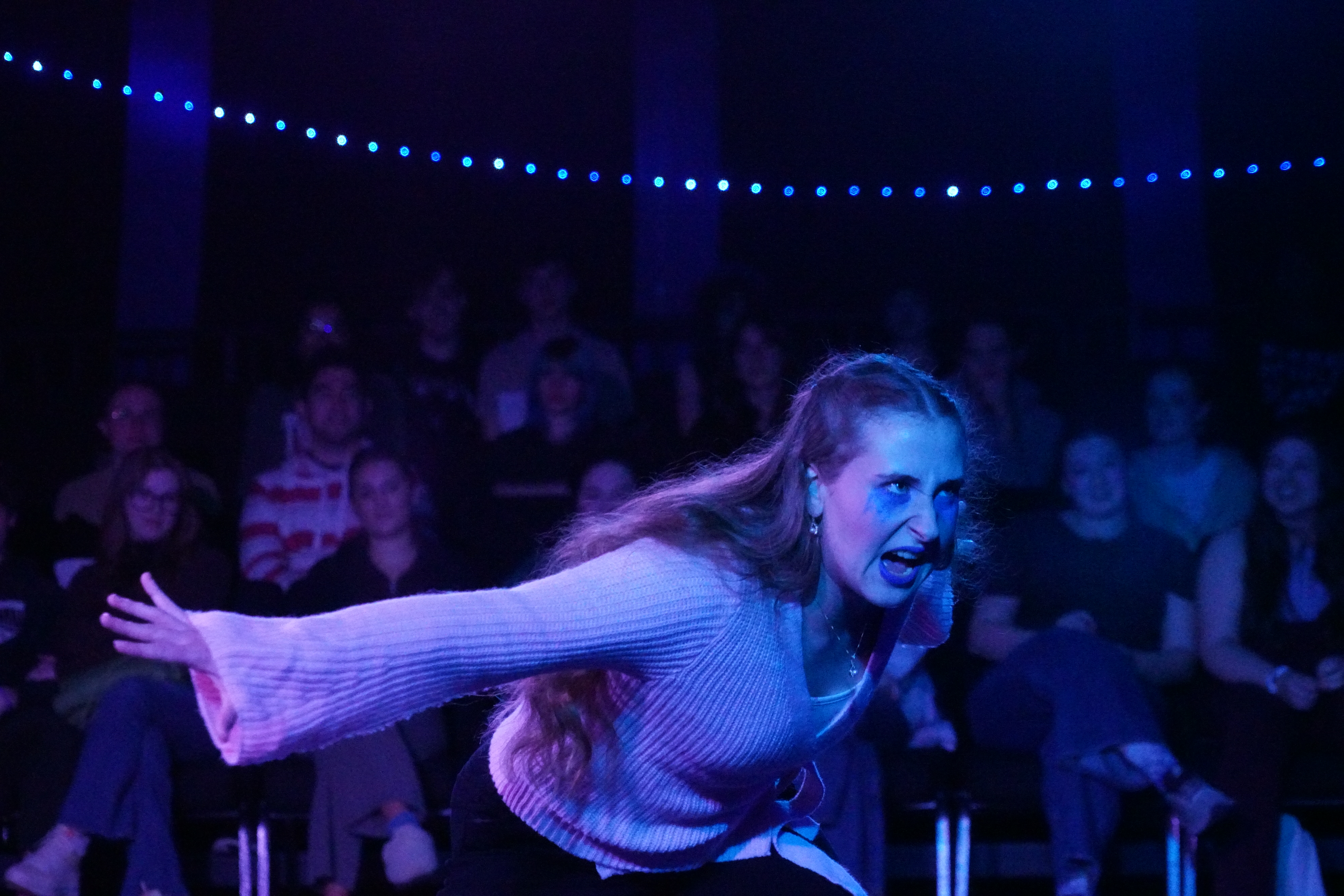 Olivia Welch as Charlotte in blue lighting during "Join Us and Die" inSecond Stage Productions "The Guy Who Didn't Like Musicals"