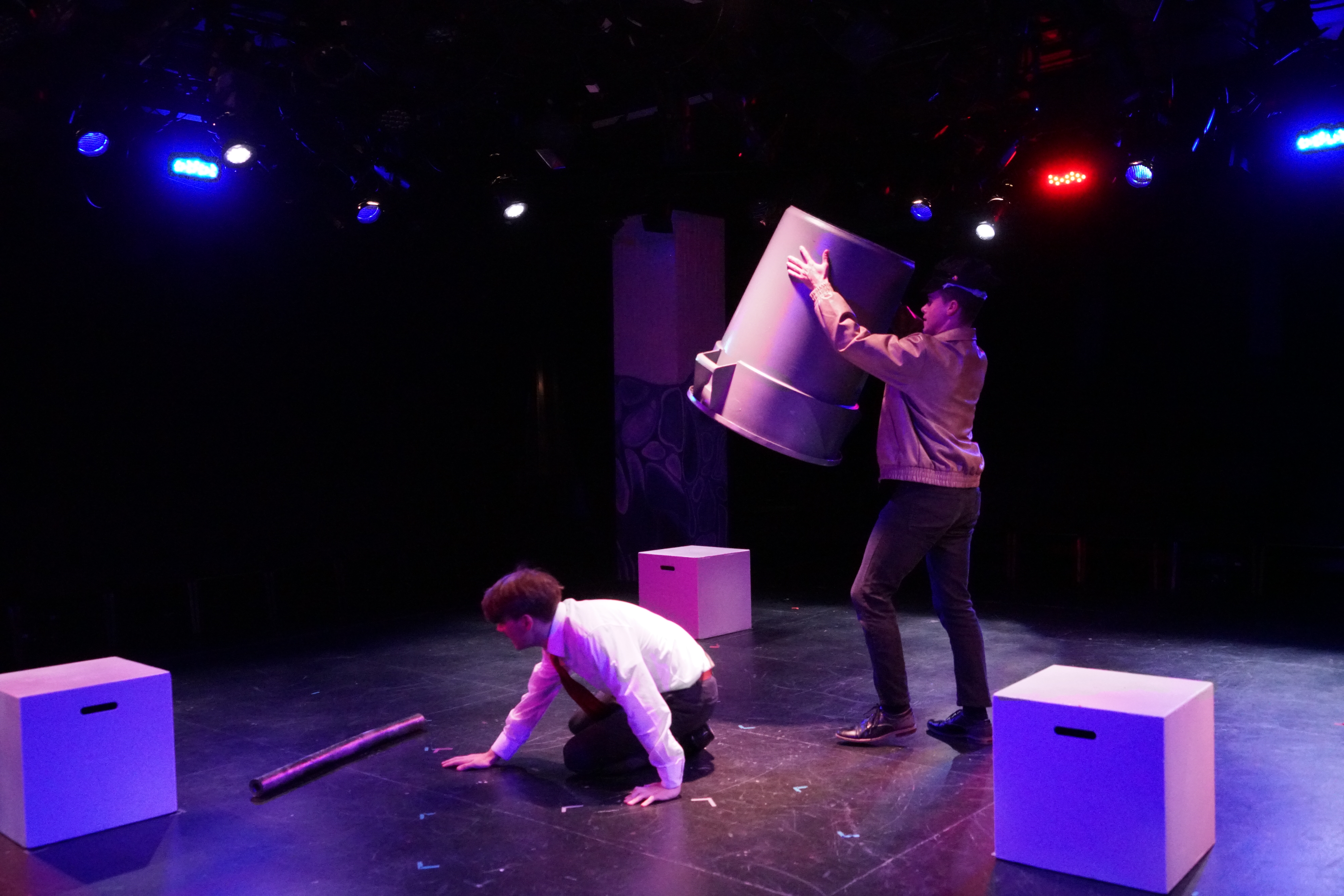 Evan Niemiec as Ted crawling out of a trashcan held by Logan Verlinde as Sam in Second Stage Productions "The Guy Who Didn't Like Musicals"