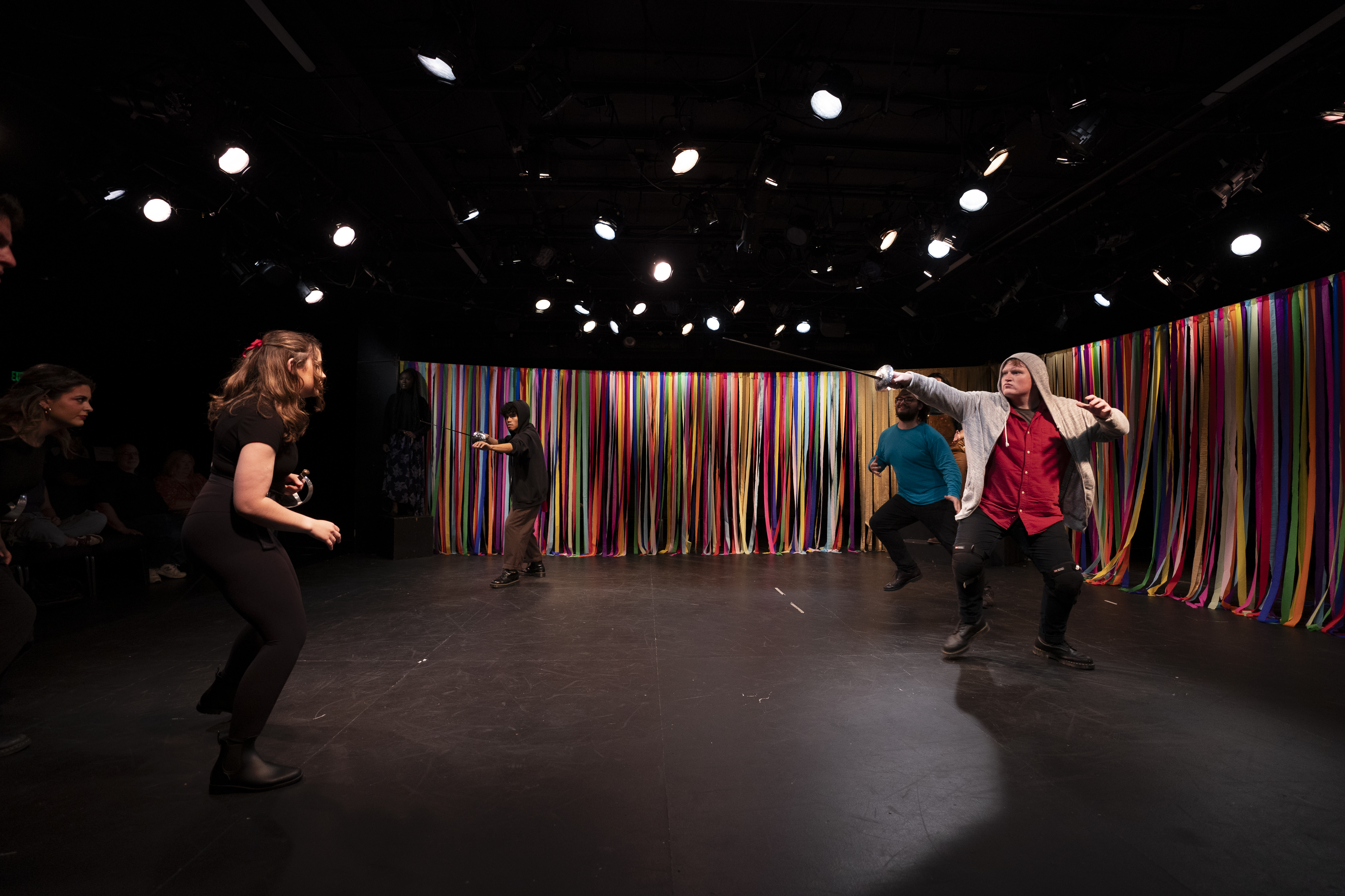 Andrew Brown playing Baco and Jhon Govaere playing Teseo pointing swords in in "Love is the Greater Labyrinth"