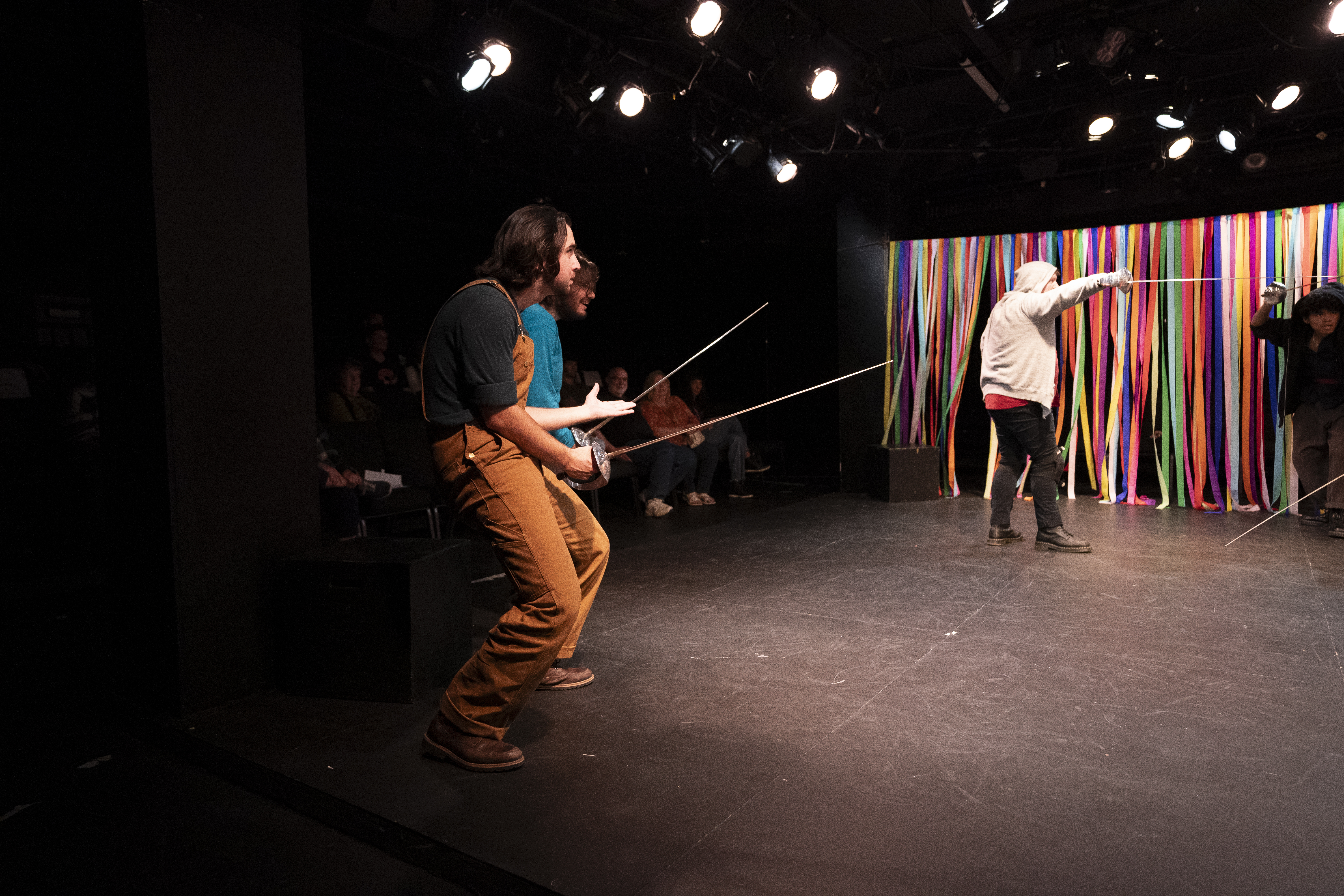Anthony Monteleone playing Vinny and Sebastian Barnett playing Tuna hold swords lewdly in "Love is the Greater Labyrinth"